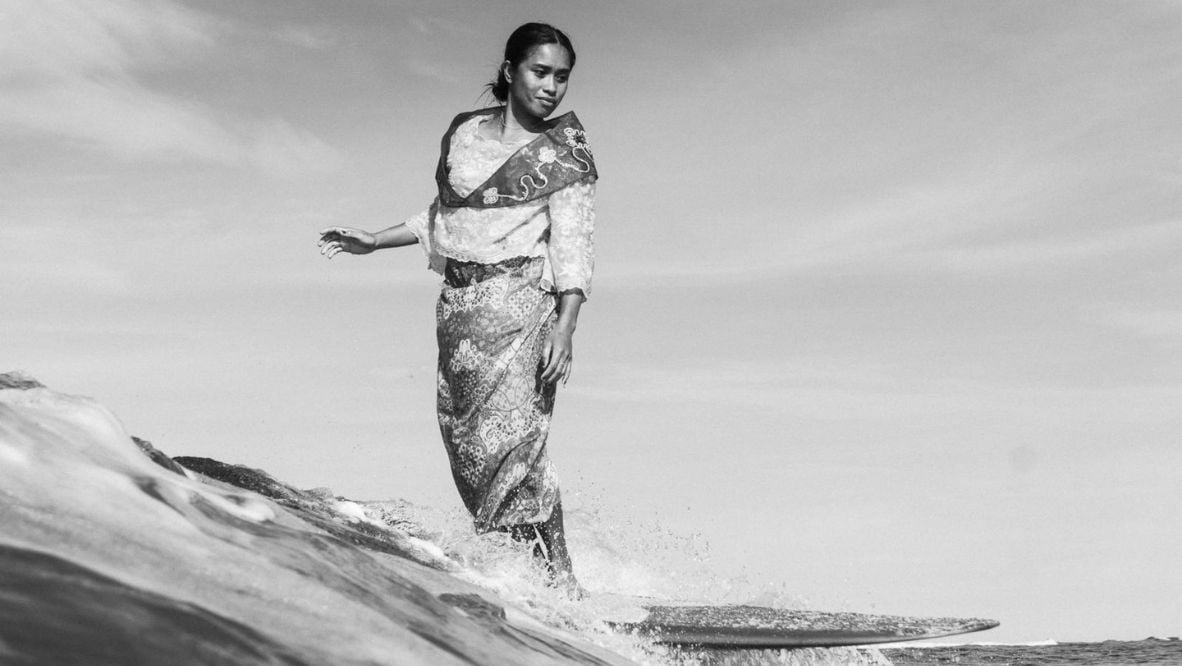 Filipina surfer Maricel Parajes rides waves wearing a Maria Clara dress, a traditional Philippine garment, for Archie Geotina’s Pearls project (Photo: courtesy of Archie Geotina)